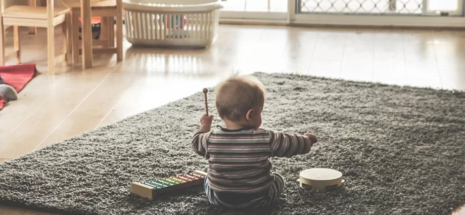 toddler playing with musical instruments